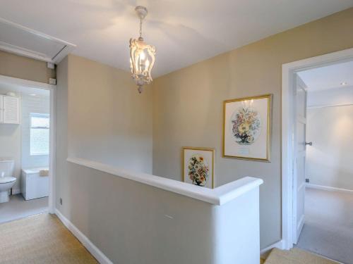 a home hallway with a chandelier and a toilet at 3 Bed in Cerne Abbas 74803 in Cerne Abbas