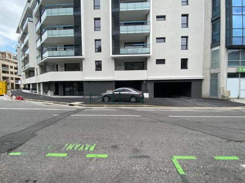 a car parked in front of a large building at Villa du Centre in Annemasse