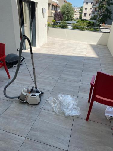 a vacuum cleaner sitting on the floor on a patio at Villa du Centre in Annemasse