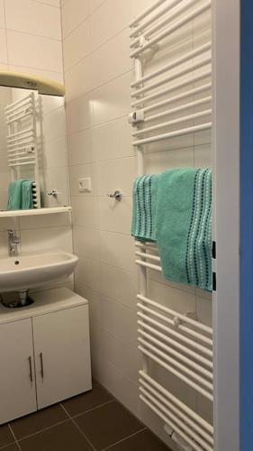 a bathroom with a sink and a mirror and towels at Apartement Fürth close Nürnberg in Fürth