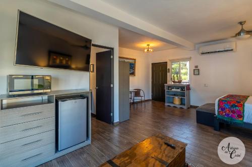 a living room with a large flat screen tv at Antigua de Cabo in Cabo San Lucas