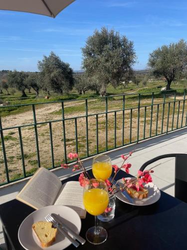 a table with two glasses of orange juice and food at Quinta da Mouracha in Águas
