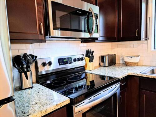 a kitchen with a stove and a microwave at Timber Point # 10 Sonja's Serenity in Branson