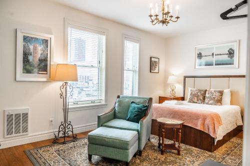 a bedroom with a bed and a chair and a lamp at Oaklands on 9th in Minneapolis