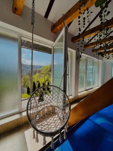 a swing in a room with a large window at Holiday Home Aladin's in Bihać