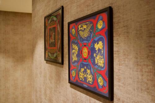 two pictures hanging on a wall in a room at 286 Piazza San Marco - Relais il Doge in Venice