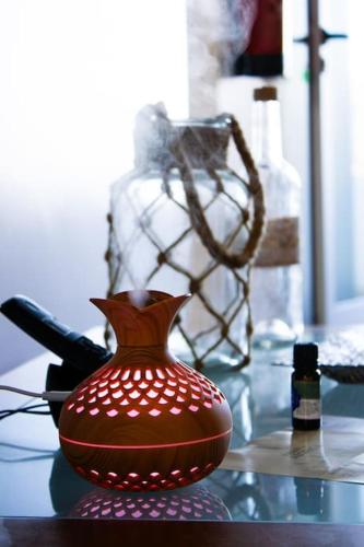 a brown vase sitting on a glass table at A Casa da Concha in Rabo de Peixe