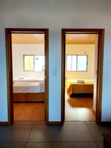 a room with two doors leading to a bedroom at A Casa da Concha in Rabo de Peixe