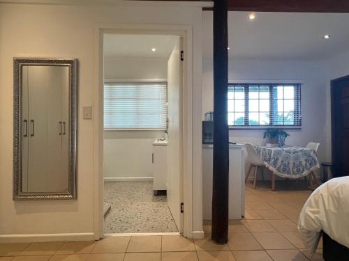 a room with a mirror and a dining room at Jefa Heights in Cape Town