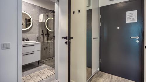 a bathroom with a shower and a sink at Rezydencja Niechorze 328 - 5D Apartamenty in Niechorze