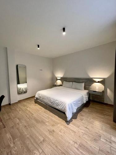 Ένα ή περισσότερα κρεβάτια σε δωμάτιο στο Capital Suites