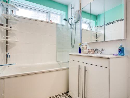a white bathroom with a shower and a sink at 2 bed in Brixham 77769 in Brixham