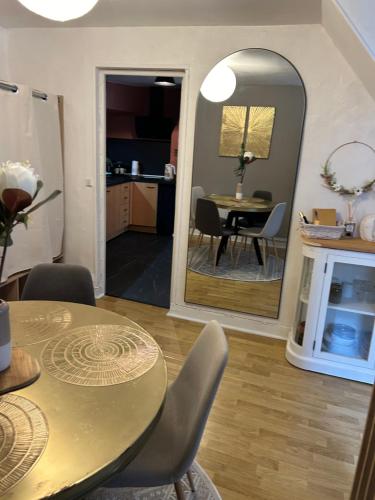 a dining room with a table and a mirror at Dieppe F2 pour 4 personnes emplacement idéal 2 min à pied de la plage et des boutiques in Dieppe