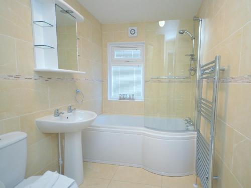 a bathroom with a tub and a sink and a shower at 3 Bed in Okehampton 49134 in Okehampton