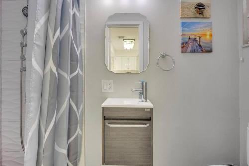 a bathroom with a sink and a mirror at Overlooking Lagoon and Pool-Free Golf Cart-Kayaks in Key Largo
