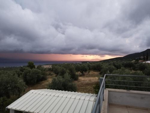 a view of the ocean from the roof of a house at Panoramic View Summerhouse in Loukísia