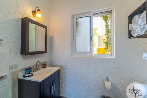 a bathroom with a sink and a window at Antigua de Cabo in Cabo San Lucas