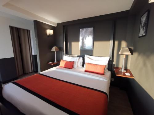 a bedroom with a large bed with orange and white pillows at Tabula Rasa Resort & Spa in Galle