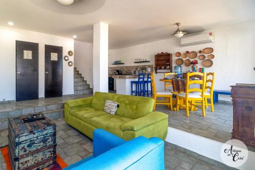 a living room with a green couch and a table at Antigua de Cabo in Cabo San Lucas
