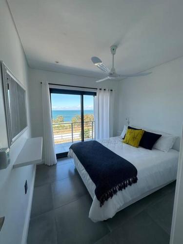 a bedroom with a large bed and a large window at Ocean View Villa - Upper in St Helena Bay