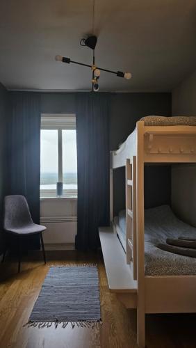 a bedroom with two bunk beds and a window at Ottsjö Wärdshus in Undersåker