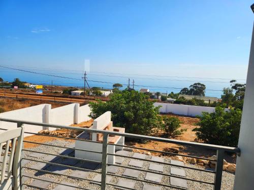 a view of the ocean from the balcony of a house at Ocean View Villa - Upper in St Helena Bay