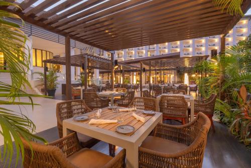 a restaurant with a table and chairs in a building at Royalton Hideaway Blue Waters, An Autograph Collection All-Inclusive Resort - Adults Only in Falmouth