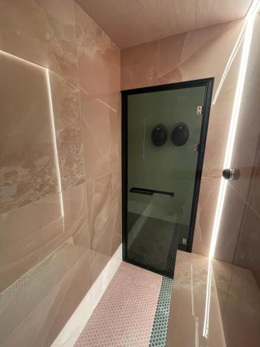 a shower with a glass door in a bathroom at 2bedroom apartment/steam room in Carnoustie