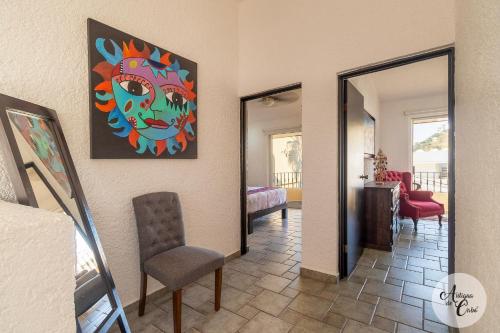 a living room with a painting on the wall at Antigua de Cabo in Cabo San Lucas