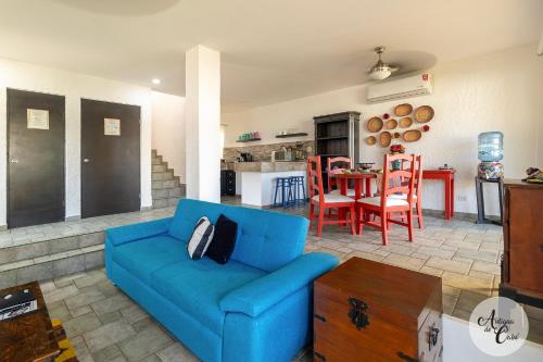 a living room with a blue couch and a table at Antigua de Cabo in Cabo San Lucas