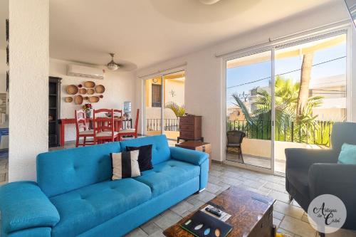a living room with a blue couch and a table at Antigua de Cabo in Cabo San Lucas