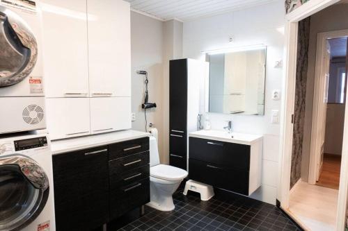 a bathroom with a toilet and a sink at Villa Ylämylly in Joensuu