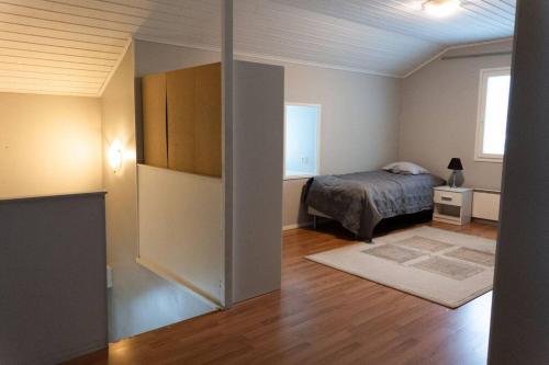 a bedroom with a bed and a room with a bed sqor at Villa Ylämylly in Joensuu