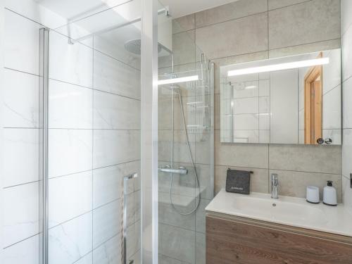 a bathroom with a shower and a sink and a mirror at Appartement lumineux avec parking, proche des pistes à Alpe d'Huez - FR-1-645-62 in LʼHuez