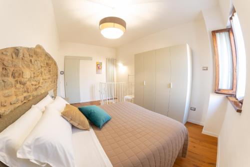 a bedroom with a large bed and a window at SIDORO Casa Vacanze in Bevagna