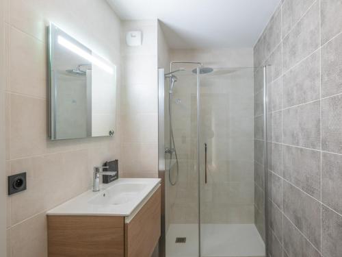 a bathroom with a shower and a sink and a mirror at Appartement Alpe d'Huez 4 adultes+2 enfants avec parking et WiFi - FR-1-645-66 in LʼHuez