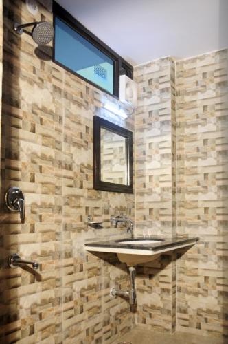 a bathroom with a sink and a mirror at Nahar Singh Haveli in Jaipur