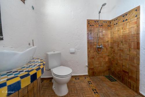 a bathroom with a toilet and a sink and a shower at Dar Bleumain in Chefchaouene