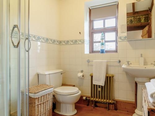 a bathroom with a toilet and a sink at 1 bed property in Gower 77981 in Penclawdd
