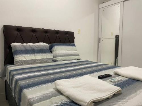 a bed with two towels on top of it at Melhor vista de Salvador, apartamento 59.03m2. in Salvador