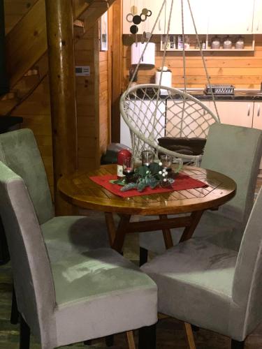 a wooden table with chairs and a tableasteryasteryasteryasteryasteryasteryasteryastery at Drinka in Ljubovija