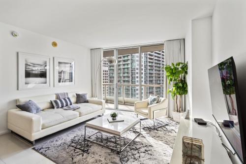a white living room with a couch and a table at Modern High Rise One Bedroom at Icon Brickell (W) in Miami