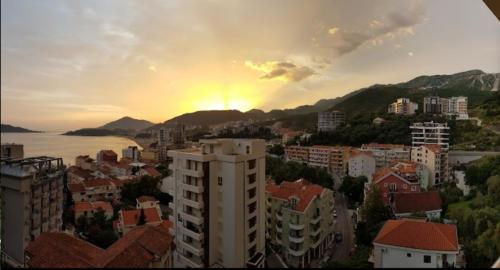 a view of a city with a rainbow in the sky at Belveder Montenegro in Rafailovici