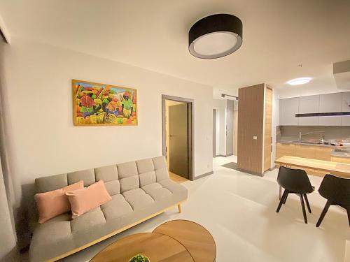 a living room with a couch and a table at Apartimento Vespa in Wrocław
