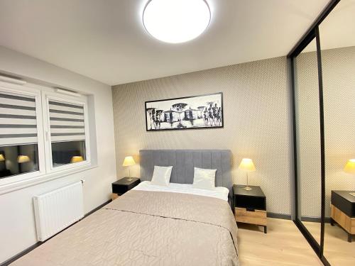 a bedroom with a bed and a window at Apartimento Vespa in Wrocław