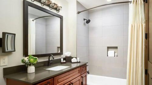 a bathroom with a sink and a shower with a mirror at Fresh SNOW! Exquisite Upscale Oasis · Ski Resort in Breckenridge