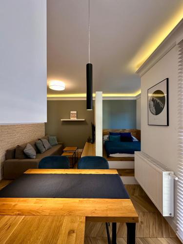 a living room with a table and a couch at Apartament Kaszubska Bryza in Hel