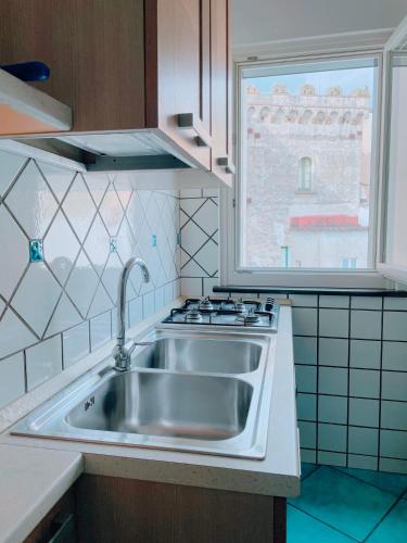 a kitchen with a stainless steel sink and a window at Putechella's Apartments in Maiori