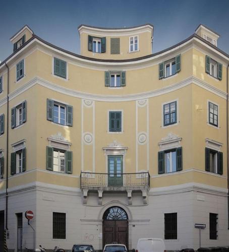 Un grand bâtiment jaune avec balcon est disponible. dans l'établissement Appartamenti della Valle, à Trieste