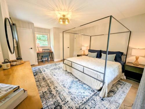 a bedroom with a canopy bed and a rug at Rustic Escape in Greenwood Lake in West Milford